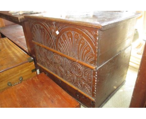 Small antique oak trunk, the hinged moulded lid above a gauge carved plank front and single drawer (with alterations)