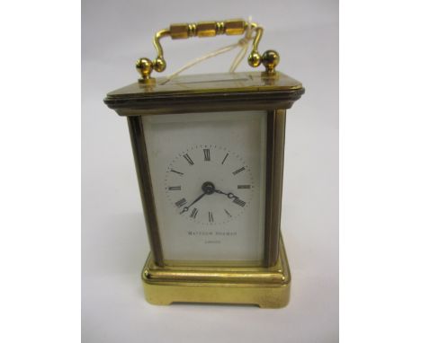 Miniature gilt brass cased carriage clock with enamel dial and Roman numerals, signed Mathew Norman, London, with a single tr