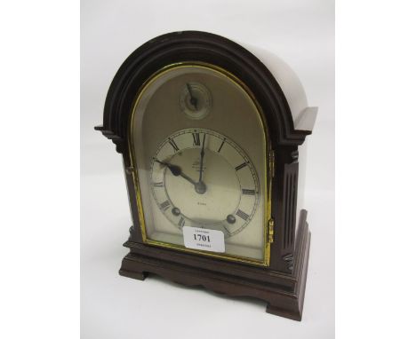 Small early 20th Century mahogany mantel clock, the arch shaped case with canted corners and shaped bracket feet, the silvere