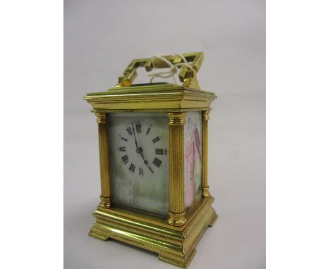 Early 20th Century miniature gilt brass cased carriage clock, the moulded case with corner pilasters and shaped carrying hand