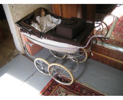 Dolls pram by Silver Cross, together with a matching bag and a modern bisque headed doll