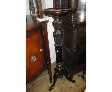 Circular carved mahogany and turned column jardiniere stand on tripod base