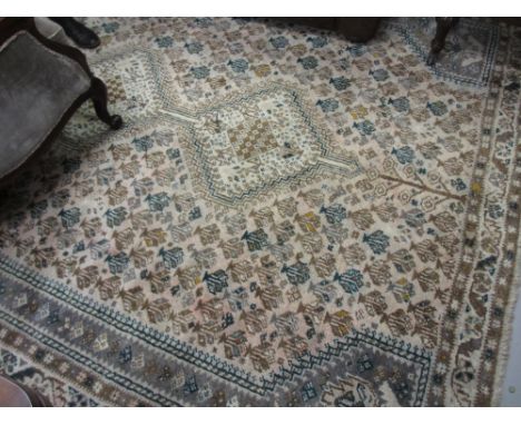 Shiraz carpet with triple pole medallion and all-over stylised floral design on a faded ground with borders, 10ft x 7ft appro