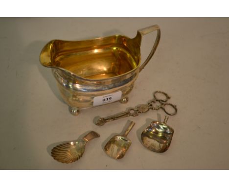 George III silver cream jug, two 19th Century silver caddy spoons, 19th Century silver shovel form spoon (a/f) and a pair of 