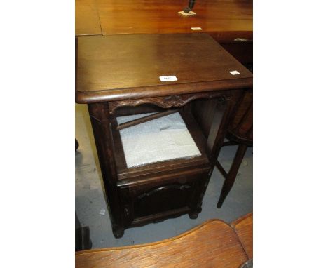 Pair of 20th Century oak bedside cabinets having floral carved decoration with single shelf, above a panelled door on low car