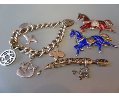 Pair of silver and enamel brooches in the form of horses together with another niello work brooch in the form of a Persian da