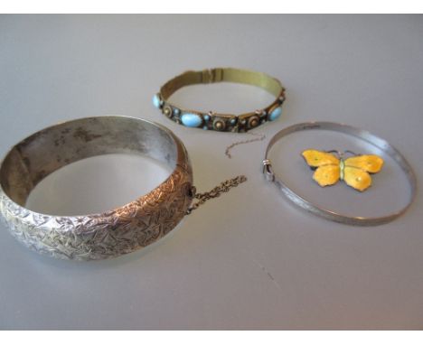 Three various bangles and an enamel butterfly brooch