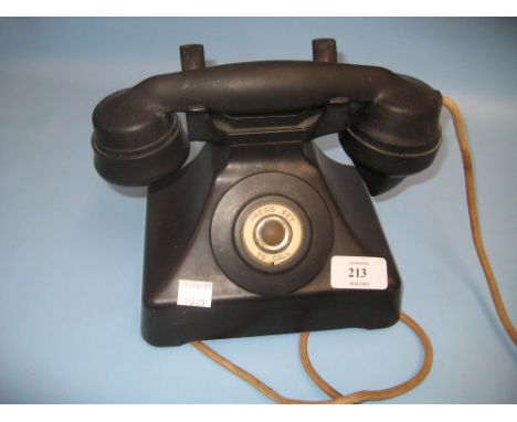 Black Bakelite telephone receiver with press key call button, circa 1930