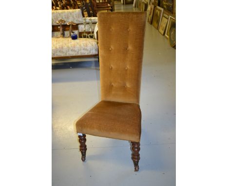 19th Century walnut high back nursing chair with button back, raised on turned tapering front supports with casters