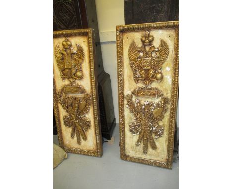 Pair of rectangular carved wooden and ghesso panels decorated in relief with double headed eagles above sword, mace and axe, 