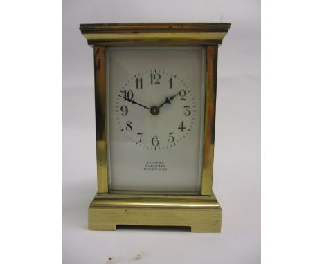Early 20th Century gilt brass cased carriage clock, the enamel dial with Arabic numerals inscribed ' Examined by D. Munsey, C