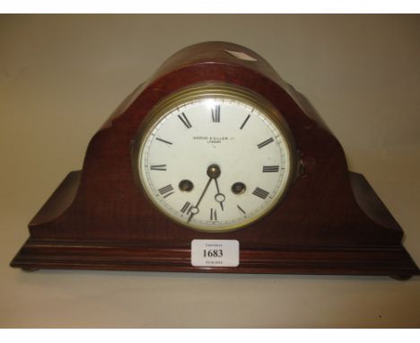 Early 20th Century mahogany dome shaped mantel clock, the enamel dial inscribed Waring and Gillow together with a Smiths oak 