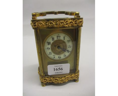 Late 19th or early 20th Century gilt brass cased carriage clock, the circular enamel dial with Arabic numerals, the case with