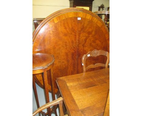 19th Century mahogany and crossbanded circular centre table, the moulded top above a turned carved baluster column support an