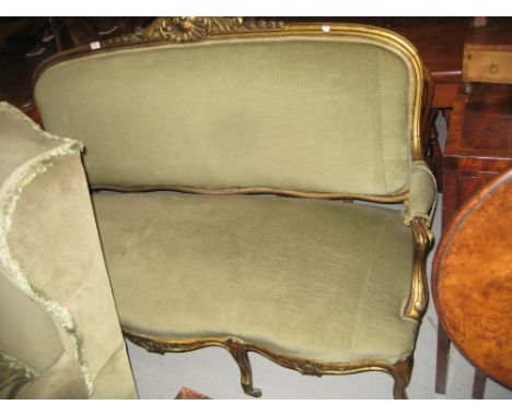 19th Century French carved giltwood and green upholstered sofa raised on cabriole front supports