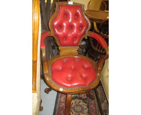 Early 20th Century oak red button upholstered revolving office chair raised on four cabriole supports