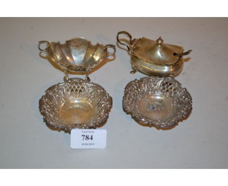 Pair of small embossed and pierced silver trinket dishes together with two silver condiments