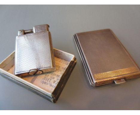 Silver cigarette lighter and a silver match case