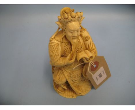 Late 19th / early 20th Century Chinese carved ivory figure of a seated gentleman reading from a scroll