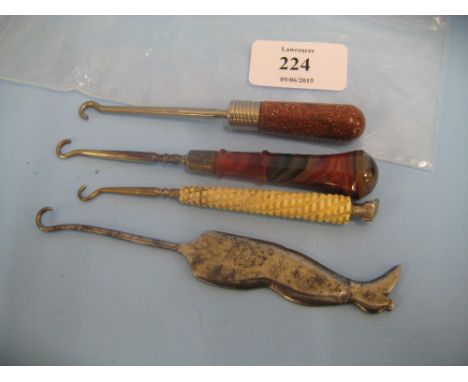 Four various 19th Century button hooks including one steel in the form of a leg