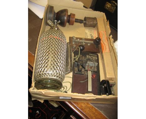 Buddhist prayer wheel on a treenware stand together with a Hohner  harmonica, a soda siphon and a morse code machine