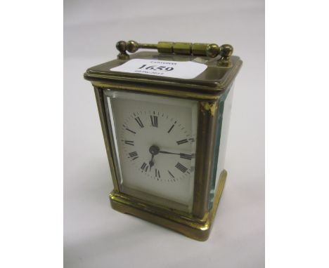 Small early 20th Century gilt brass cased carriage clock with enamel dial and Roman numerals and a single train movement