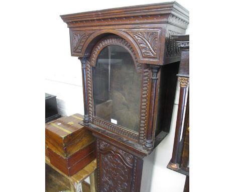 George III carved oak longcase clock case, the broken arch hood above an arched panel door and conforming plinth base with la