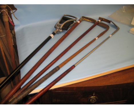 Two walking sticks, two golf clubs and a shooting stick