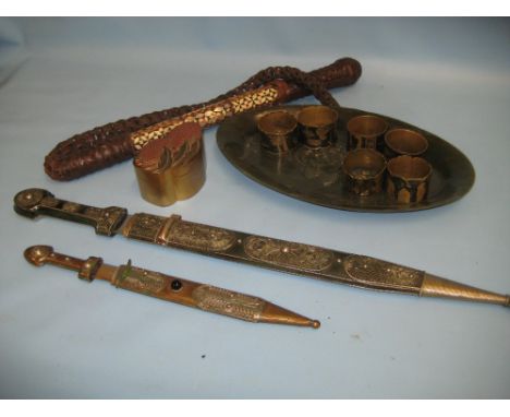 Two oriental daggers, jadeite dish, North African inlaid whip, six napkin rings and a lacquer box