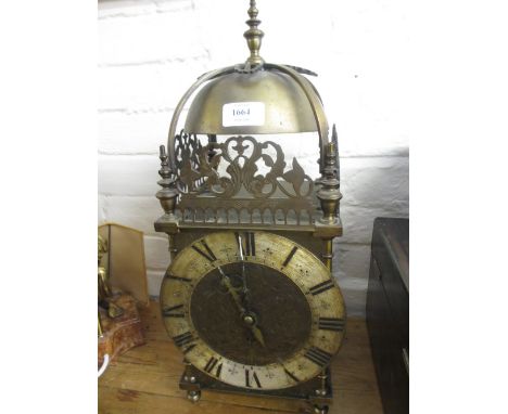 Late 19th or early 20th Century brass lantern clock in antique style, the floral engraved dial with silvered chapter ring and