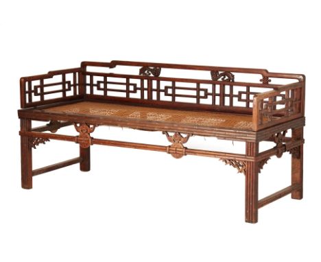 A CHINESE HARDWOOD DAYBED
With caned seat, openwork geometric back and sides, the seat rail and legs carved as bamboo and wit