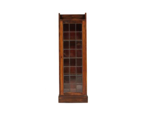 A LIBERTY &amp; CO GLAZED OAK BOOKCASE
Early 20th Century 
With a lead glazed single door and adjustable shelves on plinth ba