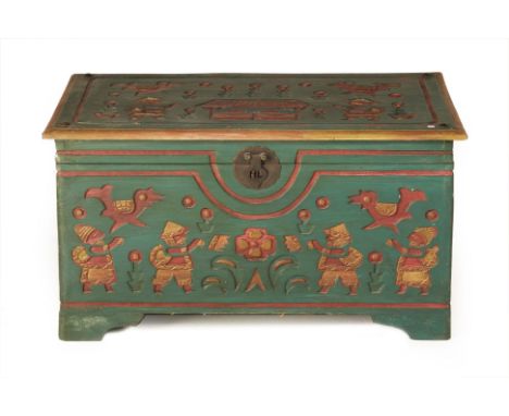 A CARVED AND PAINTED TRUNK
A carved and painted trunk with decorative Peruvian motifs, studded decoration to the top and meta
