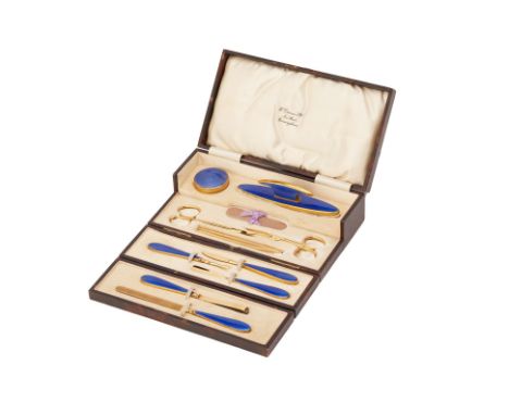 A GUILLOCHE ENAMEL MANICURE SET
Early 20th Century circa 1920
Gilt metal and blue guilloche enamel, in original fitted retail