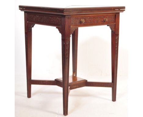 An Edwardian mahogany games card table having an envelope top fitted with baize over a single drawer with blind fretwork deco