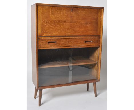 A retro vintage 20th century oak bureau cabinet having a fully appointed upper drawer over a rectangular drawer with recessed