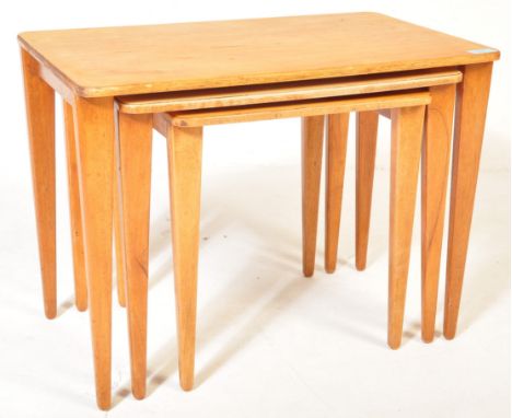 A retro vintage Gordon Russell of Broadway walnut nest of graduating tables. Raised on square tapering legs with graduating t