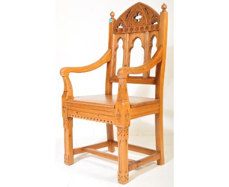 An early 20th century pine ecclesiastic Gothic church style throne chair. The charger chair headrest being of architectural f