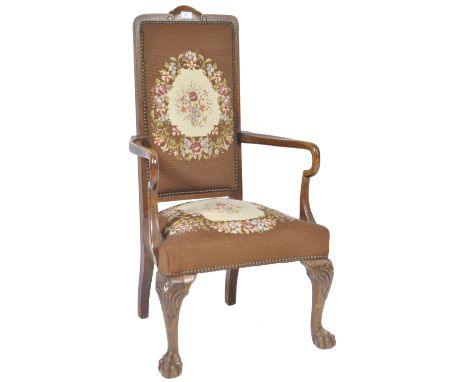 A 19th Century Queen Anne revival oak Shepherds crook armchair / arm chair having a lightly carved top back rest with studded