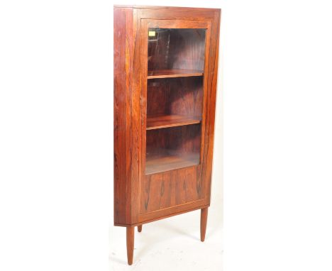 A retro vintage mid 20th century Danish afromosia teak corner cabinet having a single glazed door opening to reveal a shelved