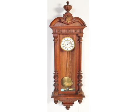 A 19th century Victorian mahogany Vienna regulator clock having a gadrooned ball finial atop a scrolled pediment, white ename