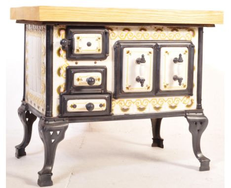 An unusual large Butchers block / kitchen island constructed from a vintage French cast iron and enamel tile wood burning sto