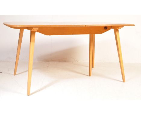 Lucian Ercolani - Ercol - A beech &amp; elm 5 legged extendable dining table of good size having a shaped good elm grain tabl