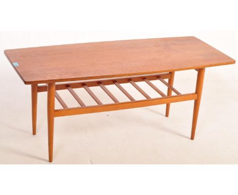 A retro vintage mid 20th century Danish inspired teak wood coffee table of rectangular form having a chamfered edge raised on