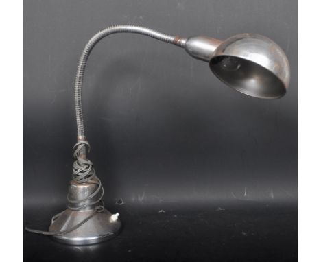 A retro vintage mid 20th century industrial chrome desk top gooseneck lamp having a domed shade on gooseneck arm upon a circu