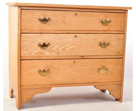 An Edwardian light oak cottage chest of drawers. Raised on bracket feet with a bank of 3 drawers under a flared chest top abo