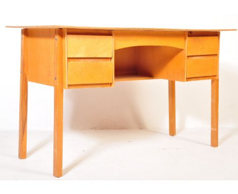A retro vintage mid 20th century circa. 1950's teak wood school desk having rectangular desk top with central knee hole flank