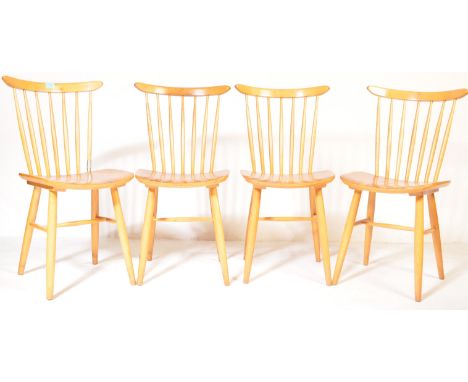 A set of four vintage retro mid 20th century Ercol style beech dining kitchen chairs having spindle backs.&nbsp;