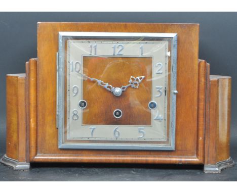 An early 20th century circa. 1930's Art Deco Norland walnut mantle clock. The mantel clock having a stepped Art Deco case wit