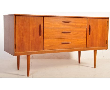 A retro vintage mid century&nbsp; circa 1960s teak sideboard. Having 3 drawers to the centre flanked by cupboards, raised on 